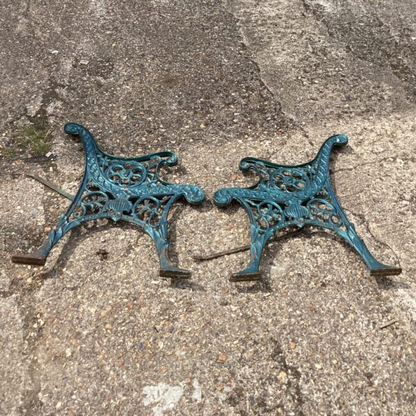 Intricate floral detailing on antique metal garden bench ends.