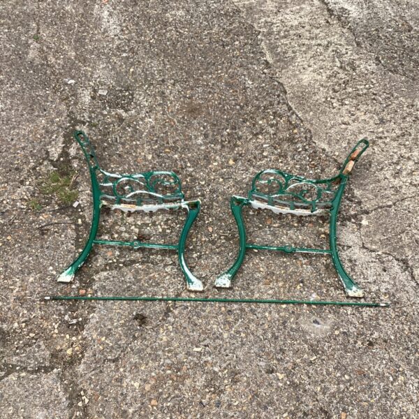 Two metal garden bench ends