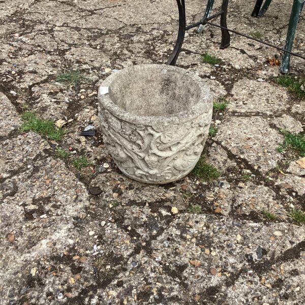 Detailed stone effect garden planter for outdoor plants.