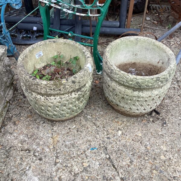 Pair of weathered stone effect garden planters for outdoor display.
