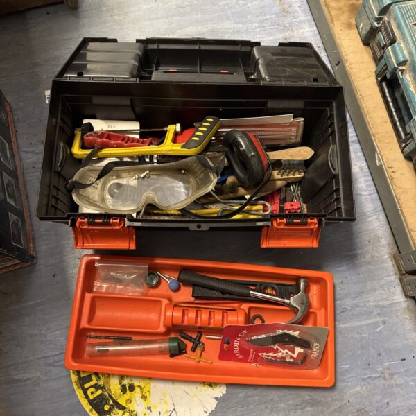 Vintage plastic toolbox filled with a set of hand tools.