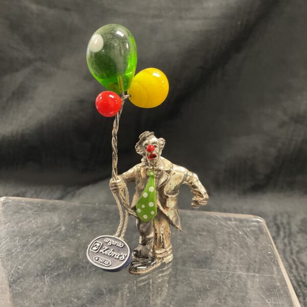 Vintage Zebras silver clown holding colourful balloons.