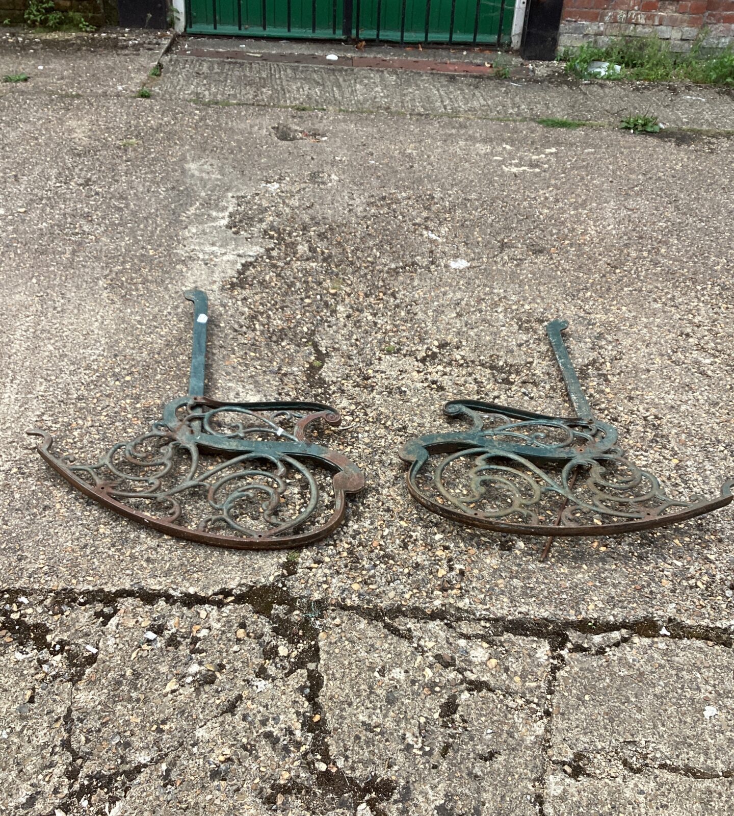 Two metal garden bench ends