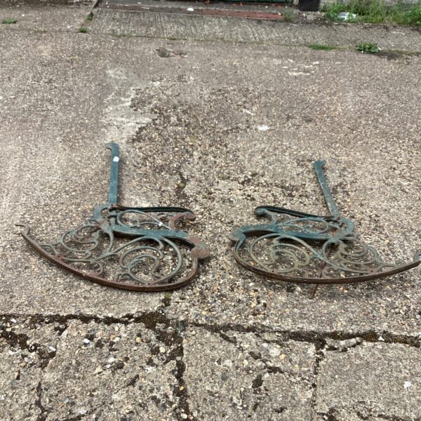 Two metal garden bench ends