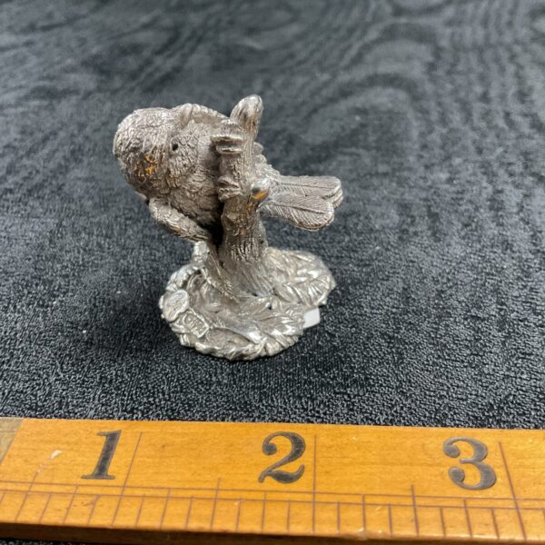 Detailed sterling silver blue tit figurine on a ruler.