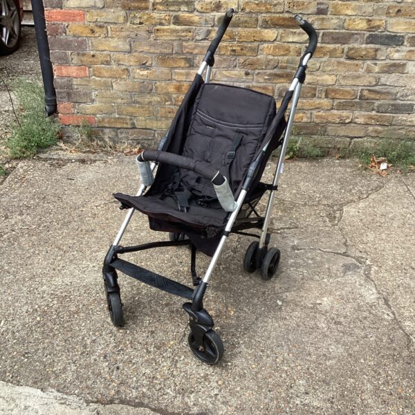 Side view of a black Huck folding pushchair.