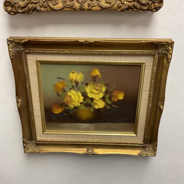 Vintage oil painting of flowers in a vase with gilt frame.