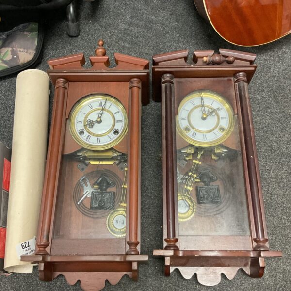Pair of vintage Highland wall clocks with wooden cases.