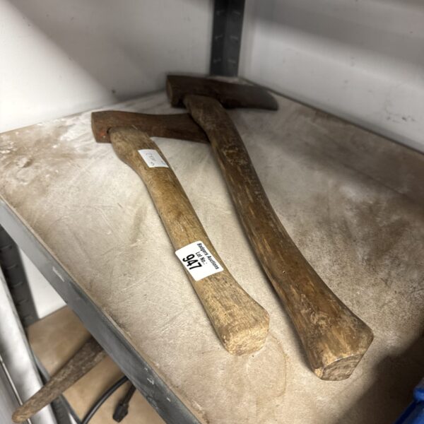 Two ancient stone hand axes, prehistoric tools for butchering and woodworking.