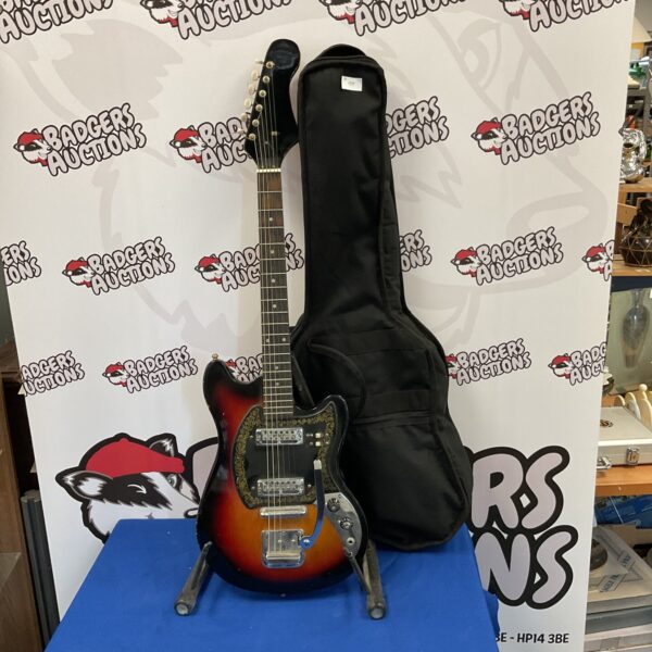 Vintage electric guitar in a hard case, collectible musical instrument.