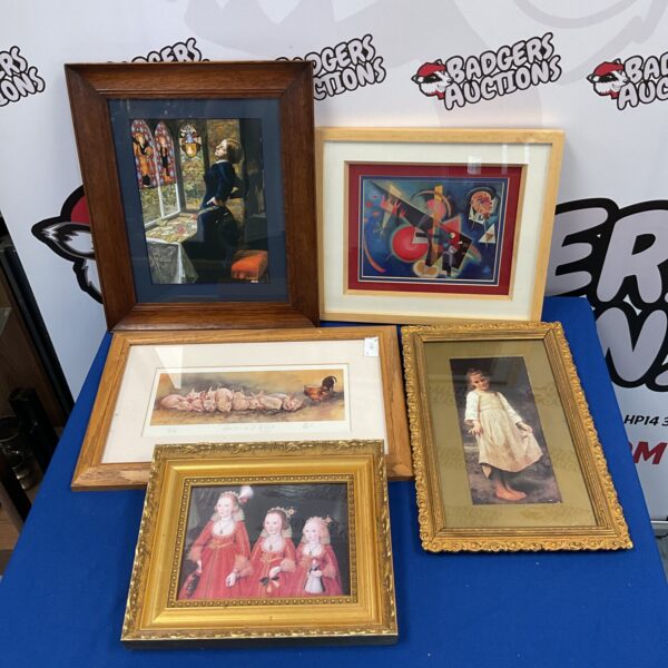 Selection of framed vintage prints for wall decor.