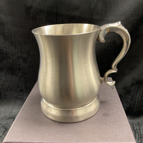Silver Wentworth pewter tankard with ornate handle and glass base.