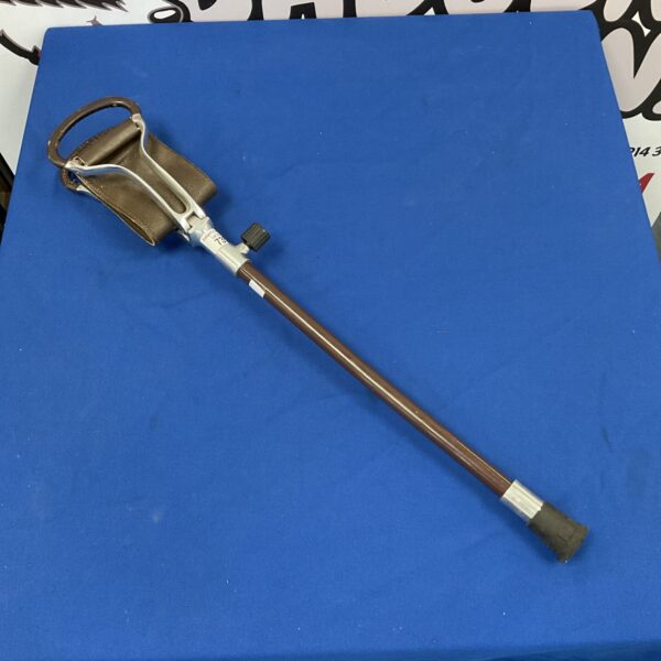 Vintage shooting stick with leather seat for hunting.