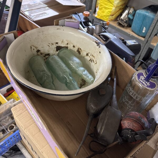 Vintage glass bottles and metal wash basin in a mixed lot.