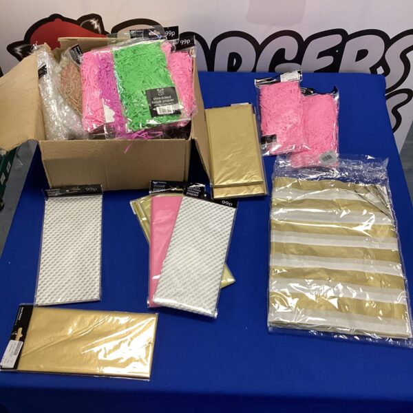 Colourful party supplies lot including shredded paper and tissue paper.