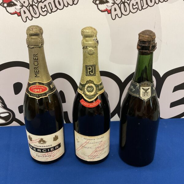 Antique champagne collection featuring Mercier 1942 and Perrier Jouet 1937 bottles.