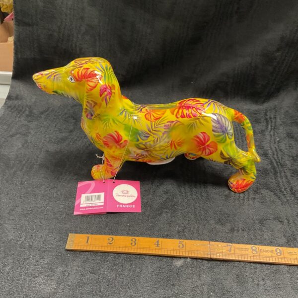 Colourful Pomme Pidoe Frankie the Dachshund ceramic money box with floral design.