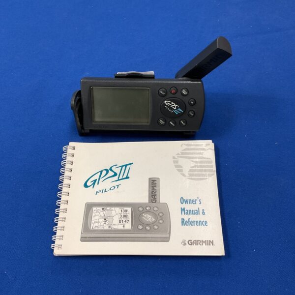 Vintage Garmin GPS III handheld GPS unit displayed.