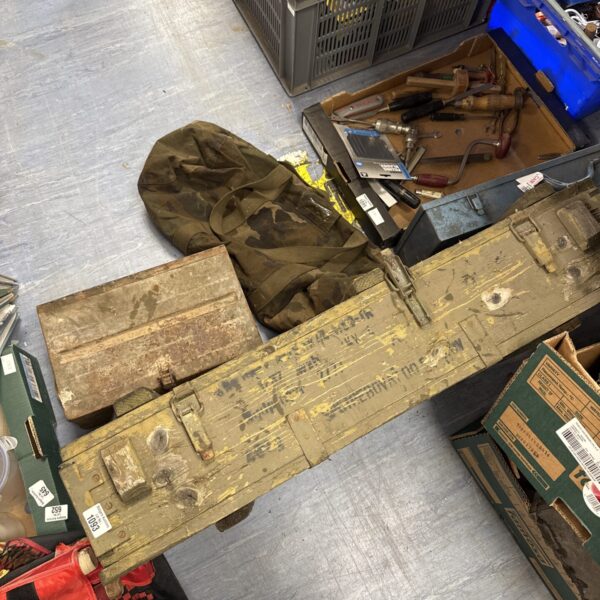 Vintage ammo crates and camo holdall for storage and collection.