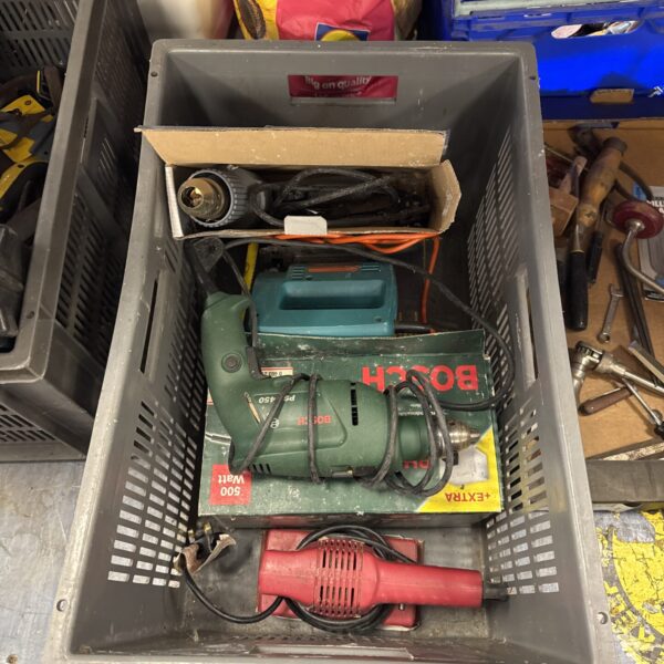 Crate of mixed power tools including a Bosch heat gun.