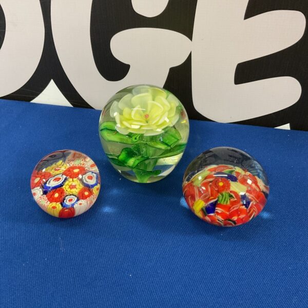 Vibrant floral glass paperweight, a beautiful desk ornament.