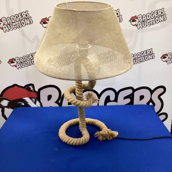 Vintage rope table lamp with beige shade for rustic decor.