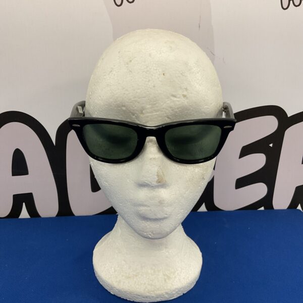Vintage Ray Ban Wayfarer sunglasses with black frames and dark lenses.