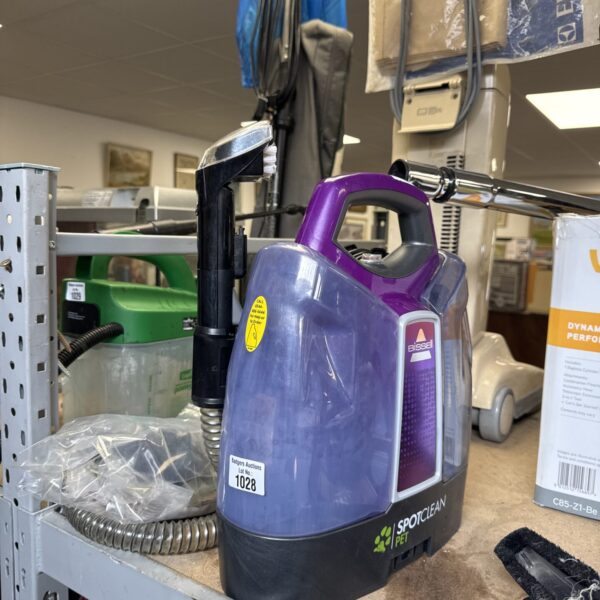 Purple Bissell SpotClean Pet handheld carpet cleaner for stain removal.