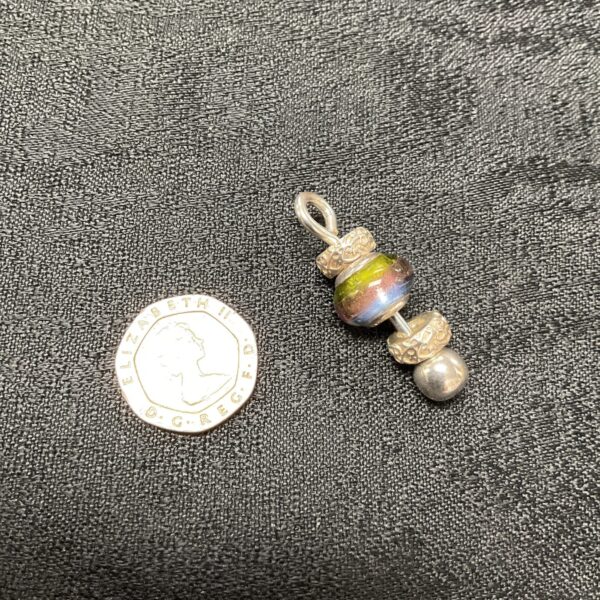 Close-up of Chamilia silver bead pendant with colourful glass.
