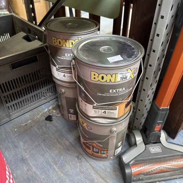 Four tins of Bondex fence paint for exterior wood protection.
