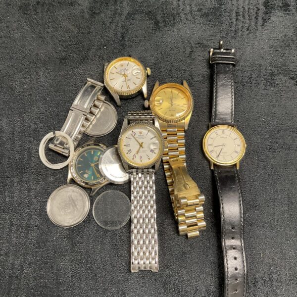 Assorted vintage watch parts lot for repair and restoration.