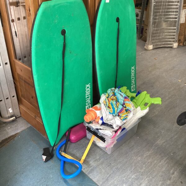 Green bellyboards and beach toys for summer fun.