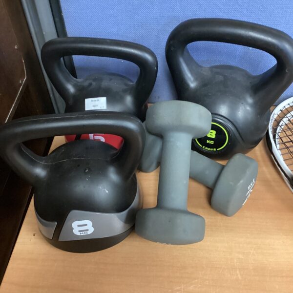 Kettlebell and dumbbell weights for home fitness training.