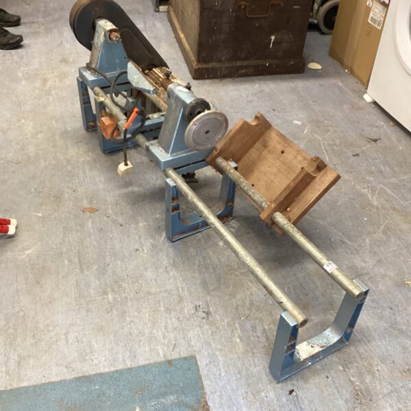 Vintage Murlachur wood turning lathe in a workshop setting.