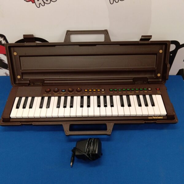 Vintage Yamaha Portasound keyboard with power supply.