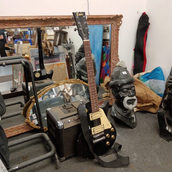 Vintage Encore electric guitar with ion amplifier, a collectible instrument.