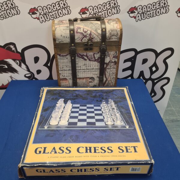 Vintage glass chess set in a travel box with map design.
