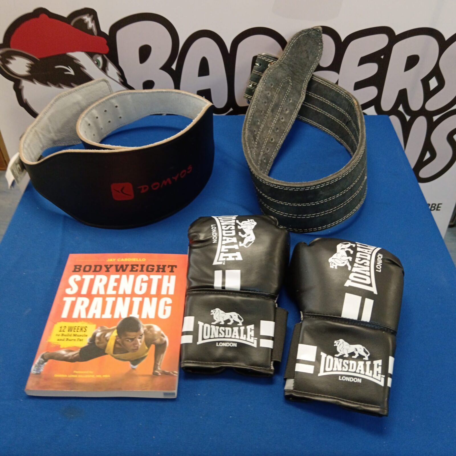 Weight lifting belts, boxing gloves & book