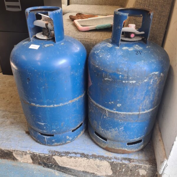 Pair of used gas bottles for camping and outdoor use.