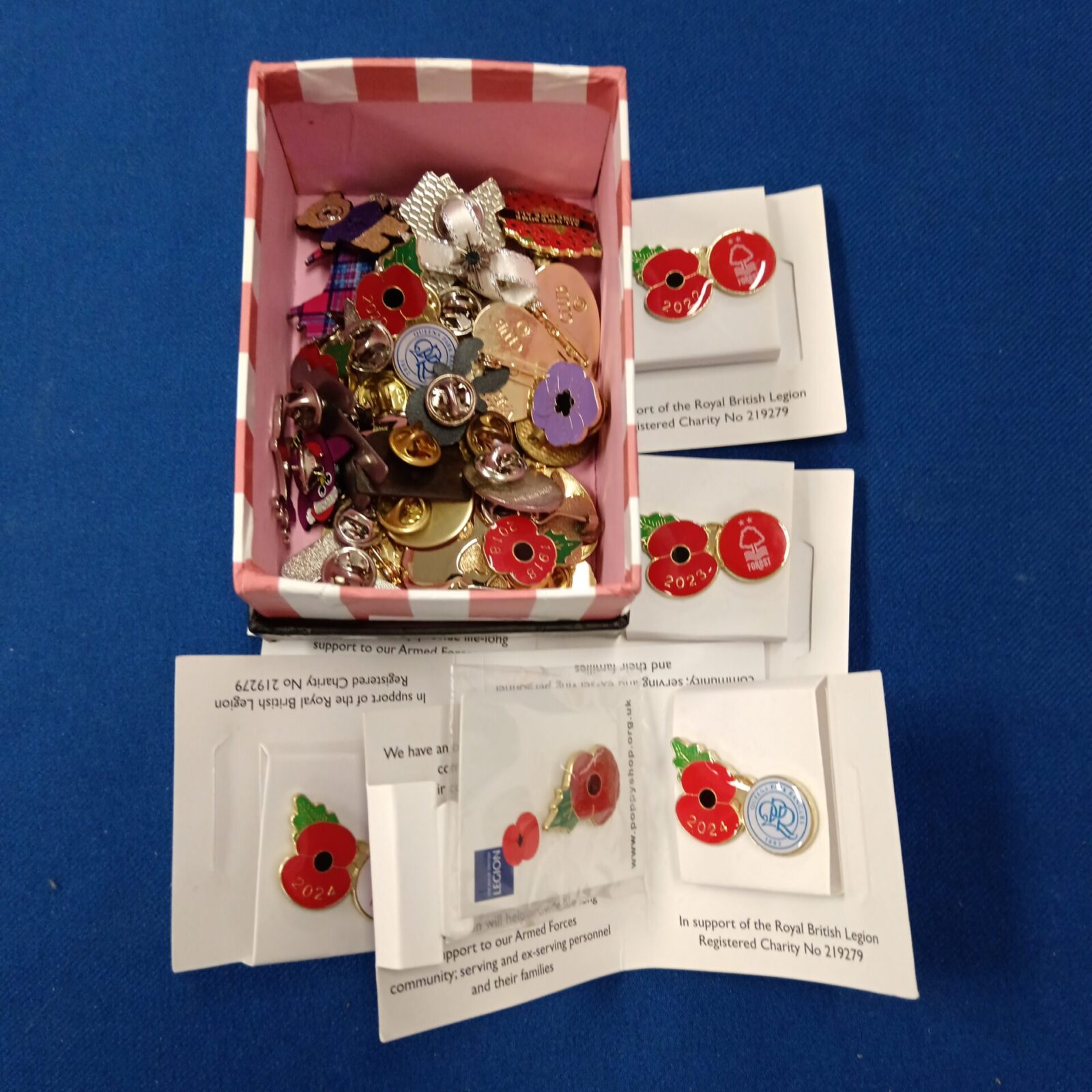 Collection of pin badges including poppies & butlins