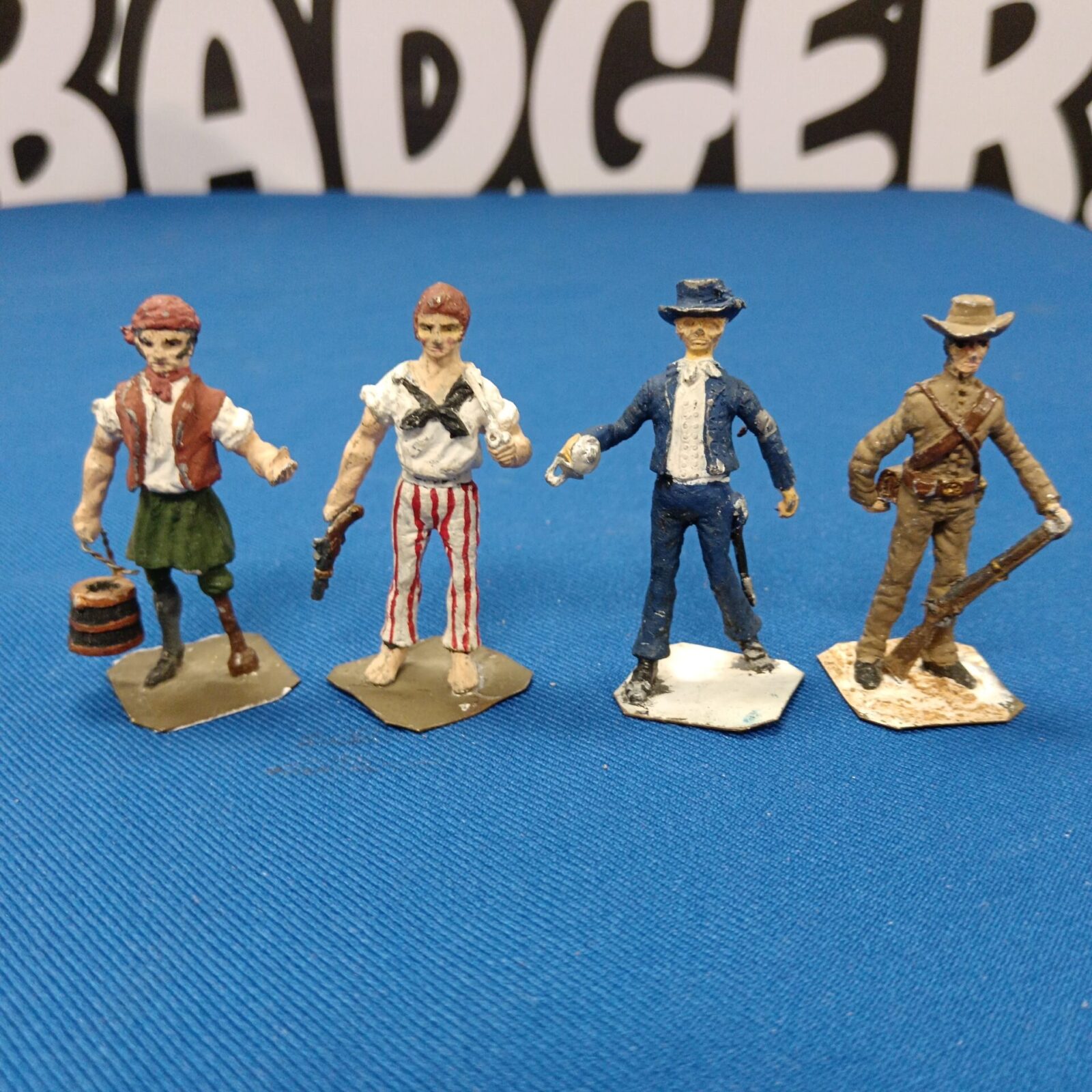Four vintage lead cowboy & pirate figures