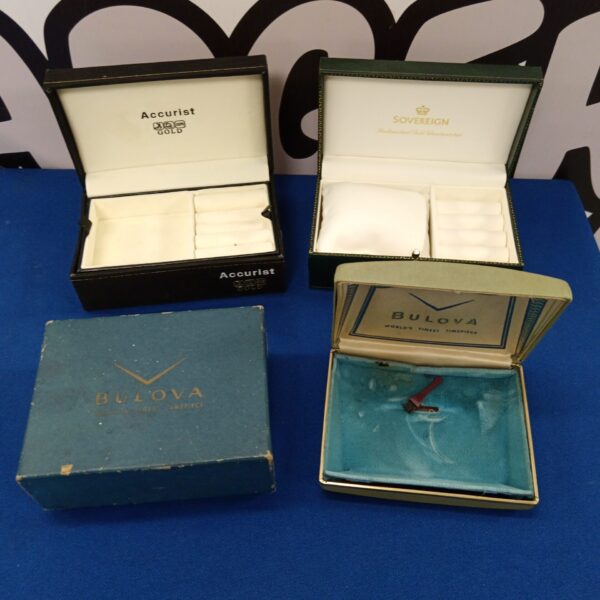 Three empty designer watch boxes including bulova, accurist & sovereign