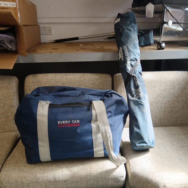 Car cover, ground sheet, and folding chair set for outdoor use.