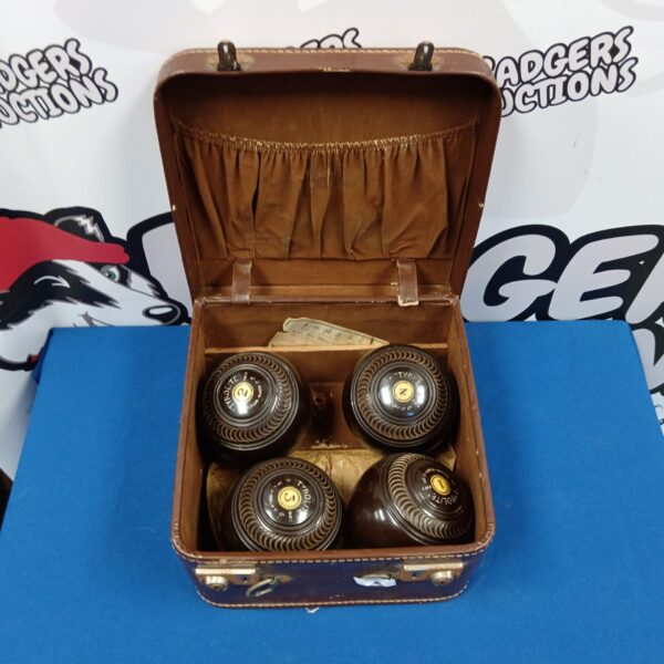 Set of four vintage tyrolite lawn bowls in case