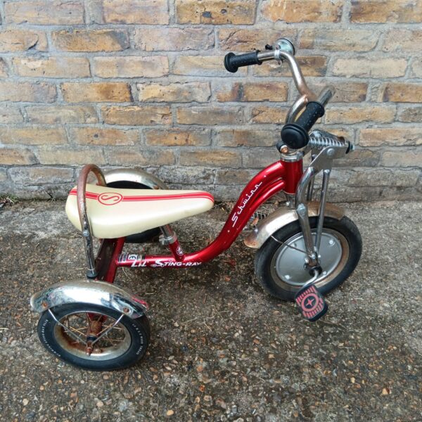 Vintage red Schwinn Stingray trike, a classic child's toy.