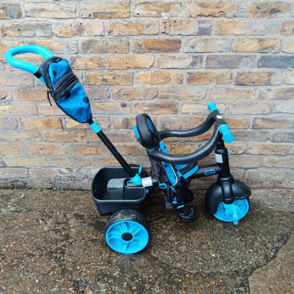 Blue Little Tikes trike with push handle for toddlers.