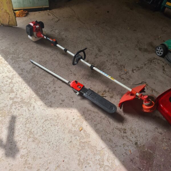 Red garden multi tool with long reach handle for landscaping.