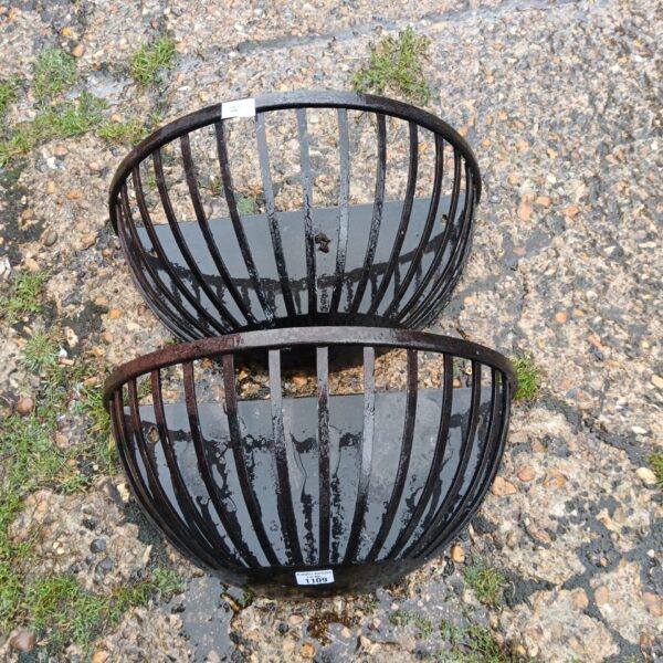 Pair of weathered aluminium wall planters for garden display.