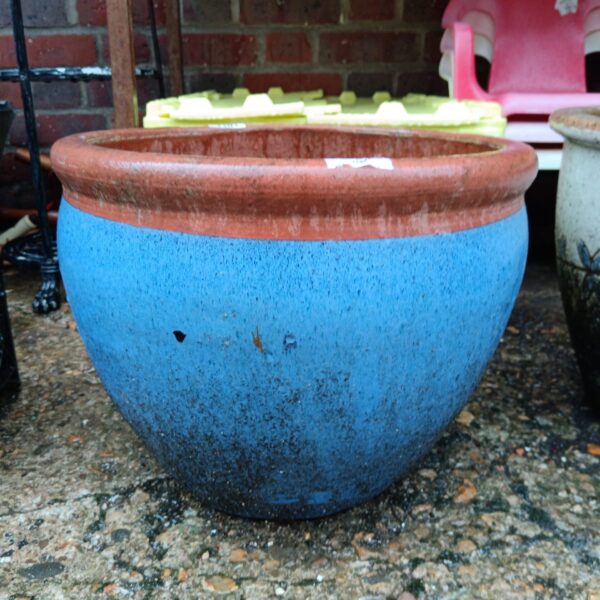Large blue glazed garden pot for outdoor plants.