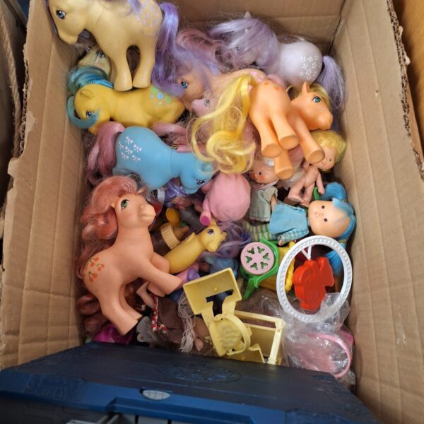 Vintage My Little Pony figures and Battleship game in a toy lot.